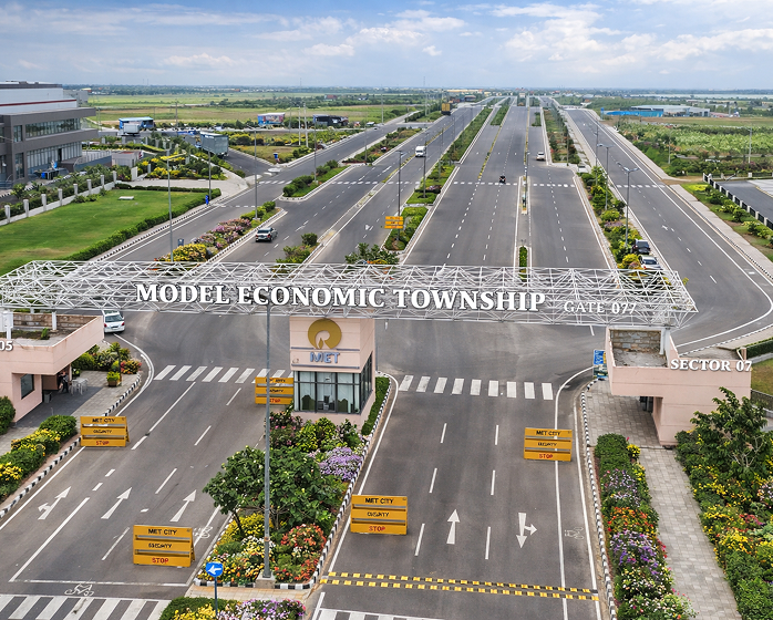 Aerial view of MET City entrance gate and landscaped road network