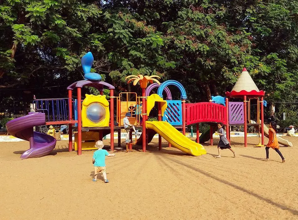Children's playground with slides in a wooded MET City park