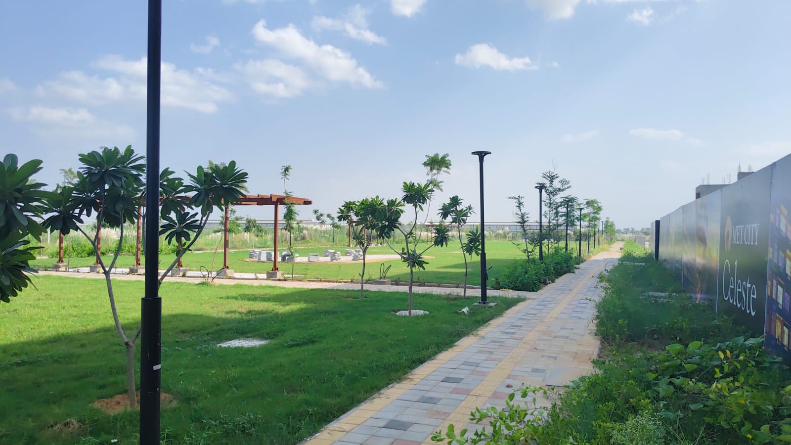 Landscaped park and walkway beside MET City Celeste