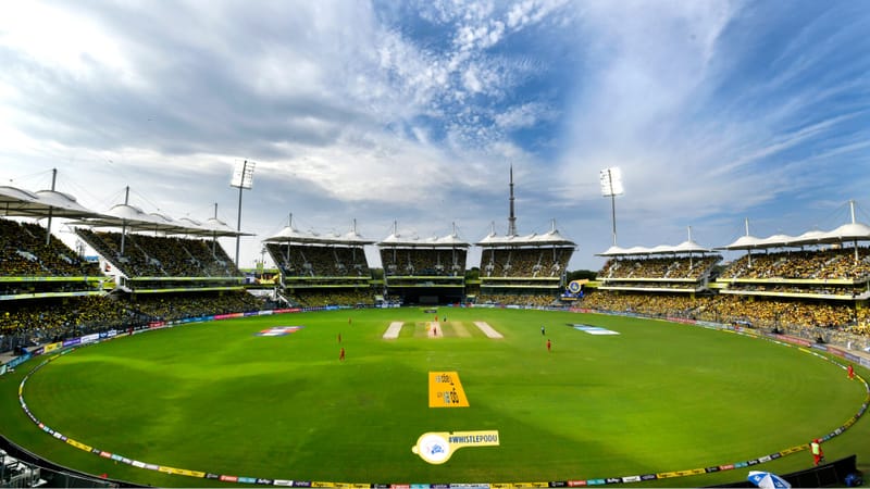 Packed international cricket stadium during a day match
